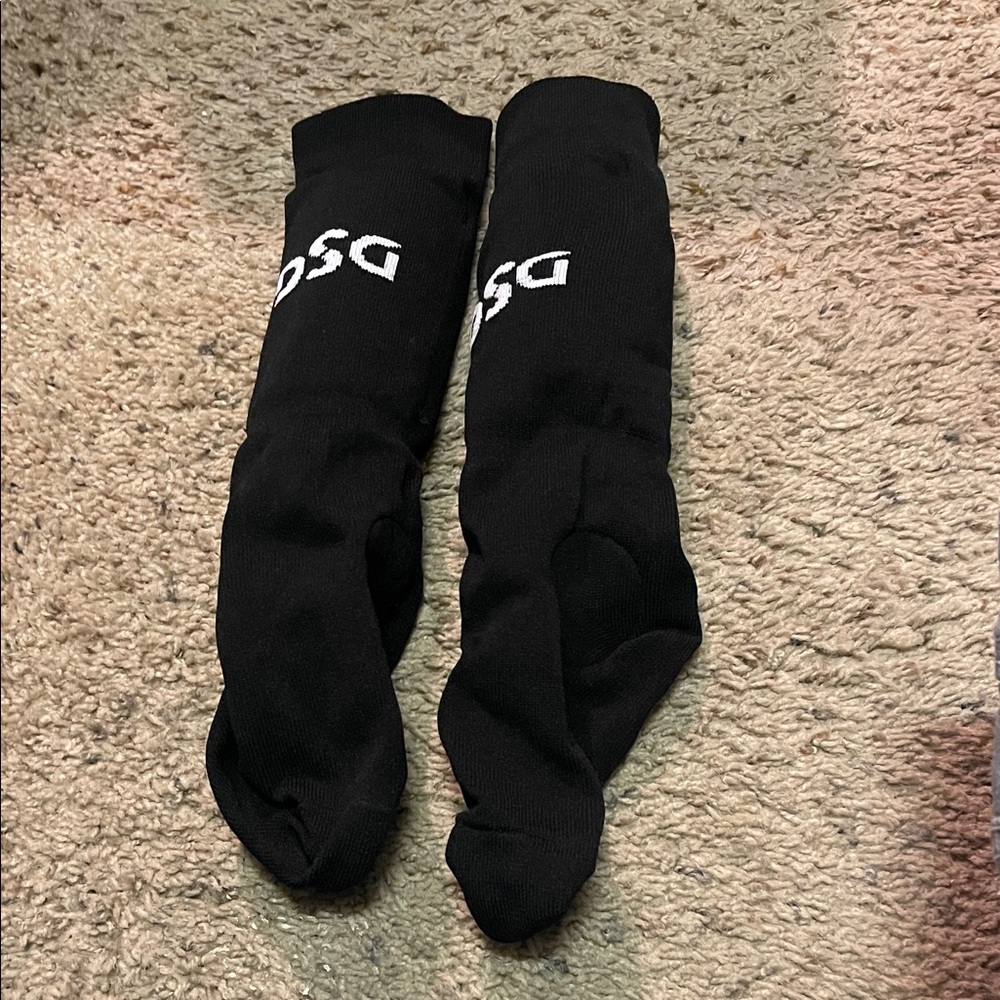 Black and white soccer socks with padding.